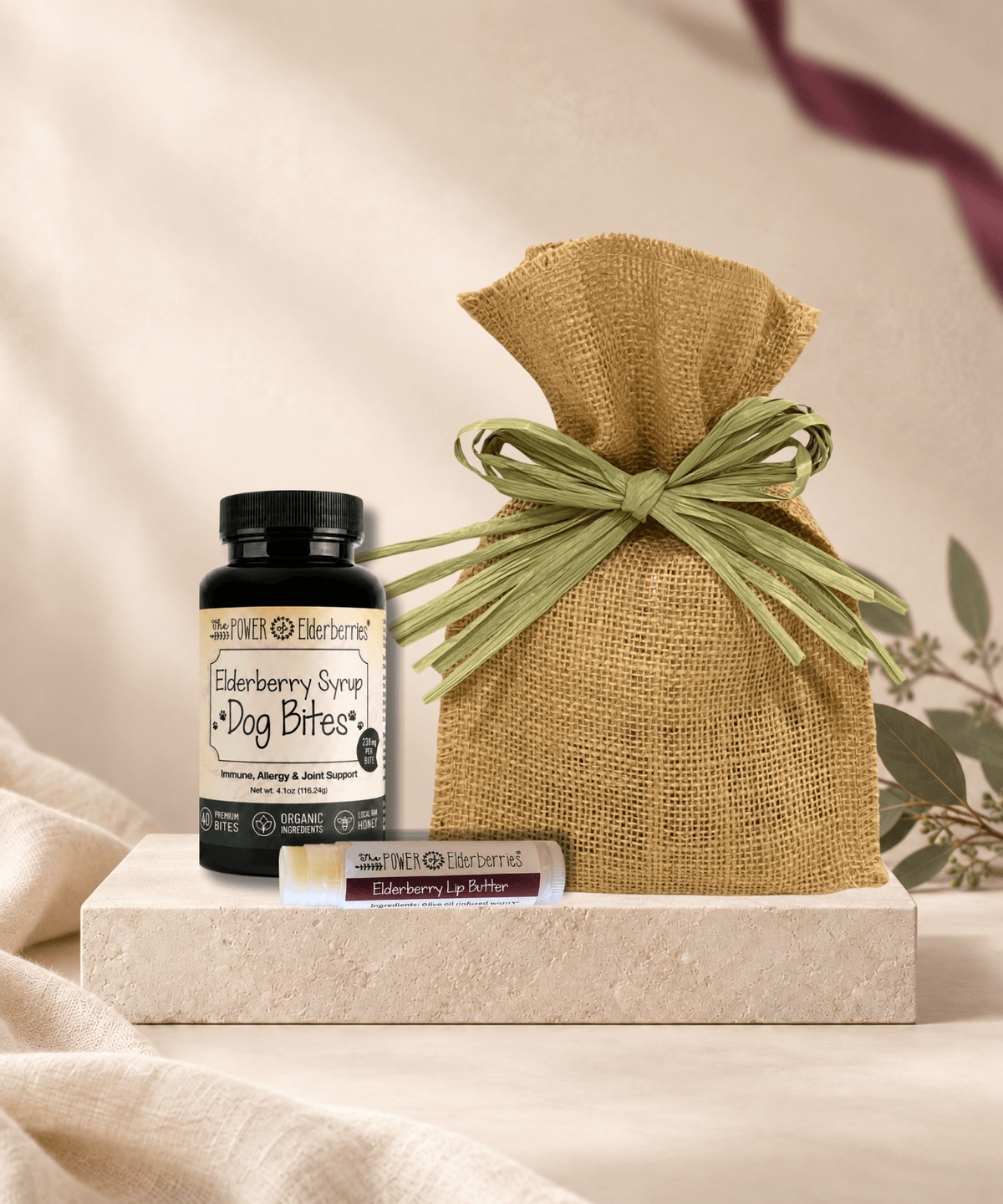 Canine Wellness Gift Set with 40-count Elderberry Syrup Dog Bites, Elderberry Lip Butter for the pet parent, and a burlap gift bag.