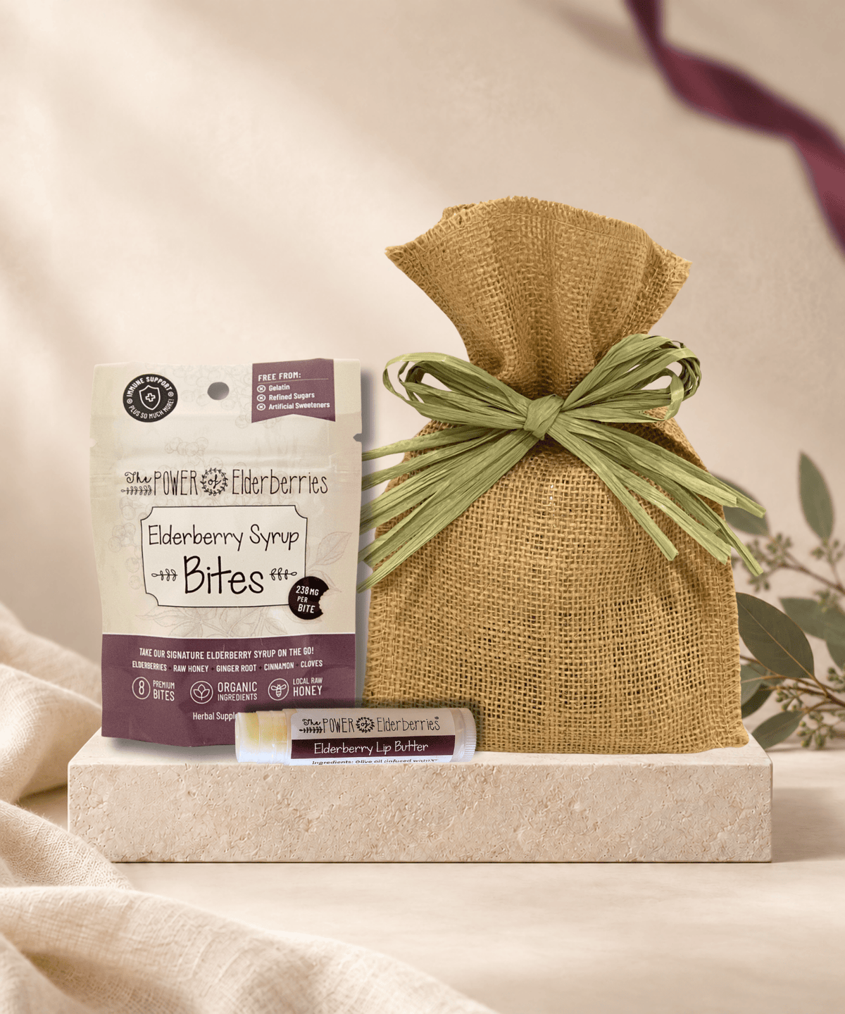Petite Daily Wellness Gift Set with 8-count Elderberry Syrup Bites, Elderberry Lip Butter, and a burlap gift bag.