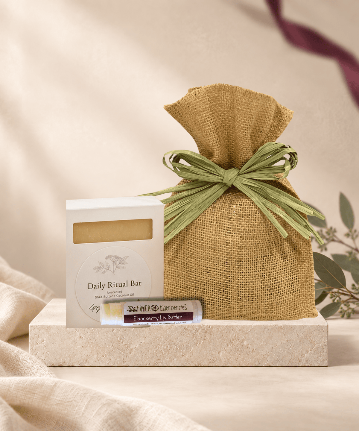 Simple Comfort Gift Set with handcrafted soap, local raw honey, Elderberry Lip Butter and a burlap bag with green raffia bow.