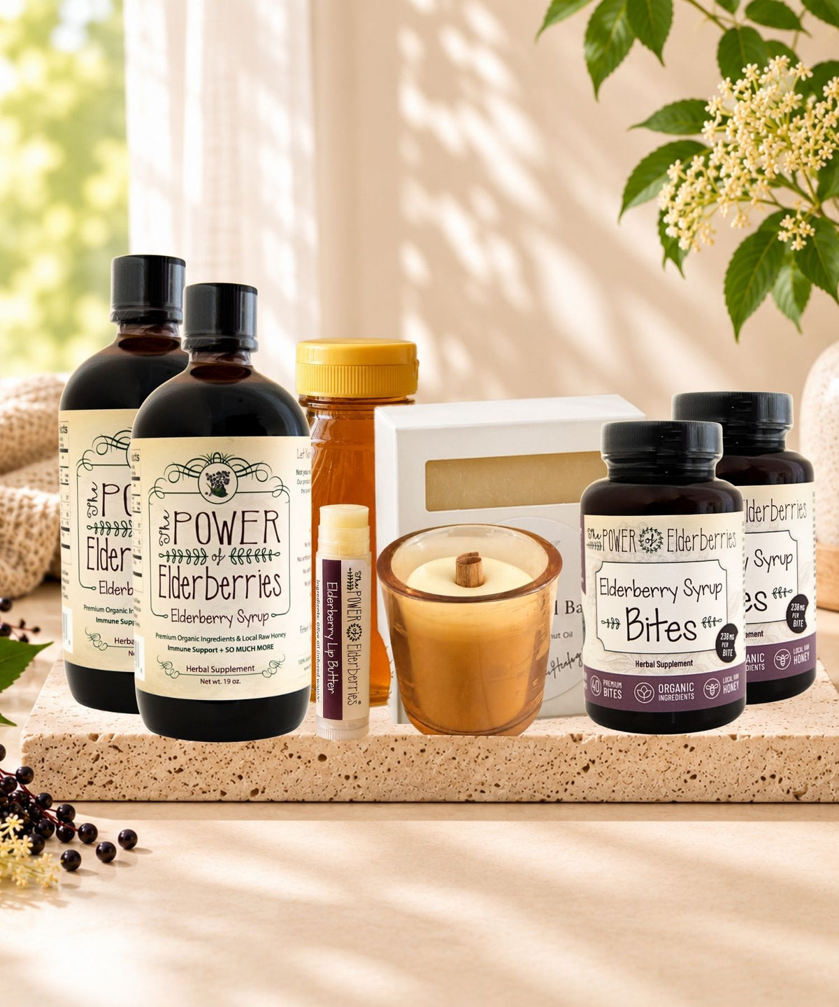 Complete Wellness Ritual Plus+ Bundle with two elderberry syrups, two Bites, honey, lip butter, candle, and soap