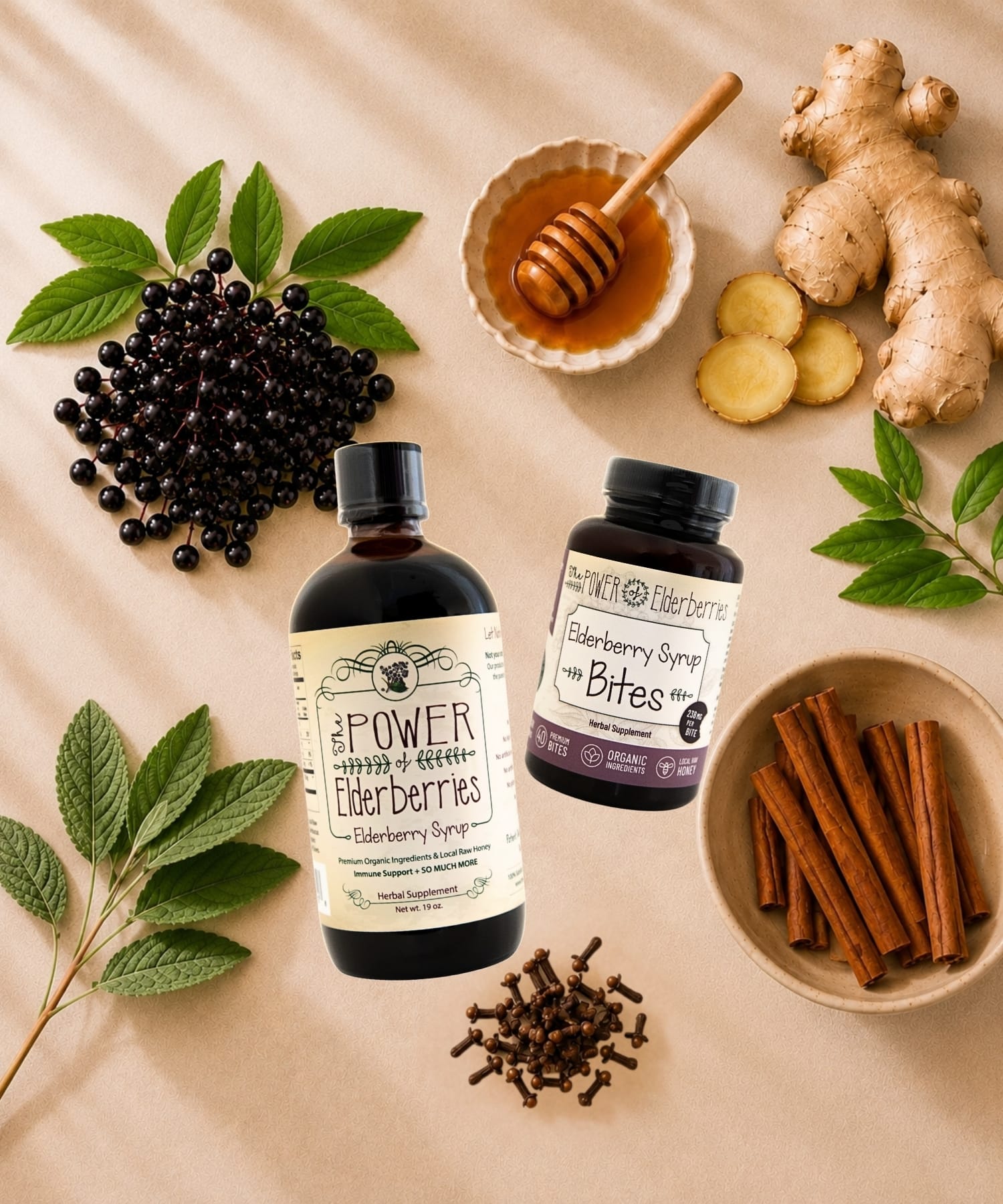 An ingredient flat lay with black elderberries, raw honey, ginger root, cinnamon sticks and whole cloves surround a bottle of elderberry syrup and elderberry bites.