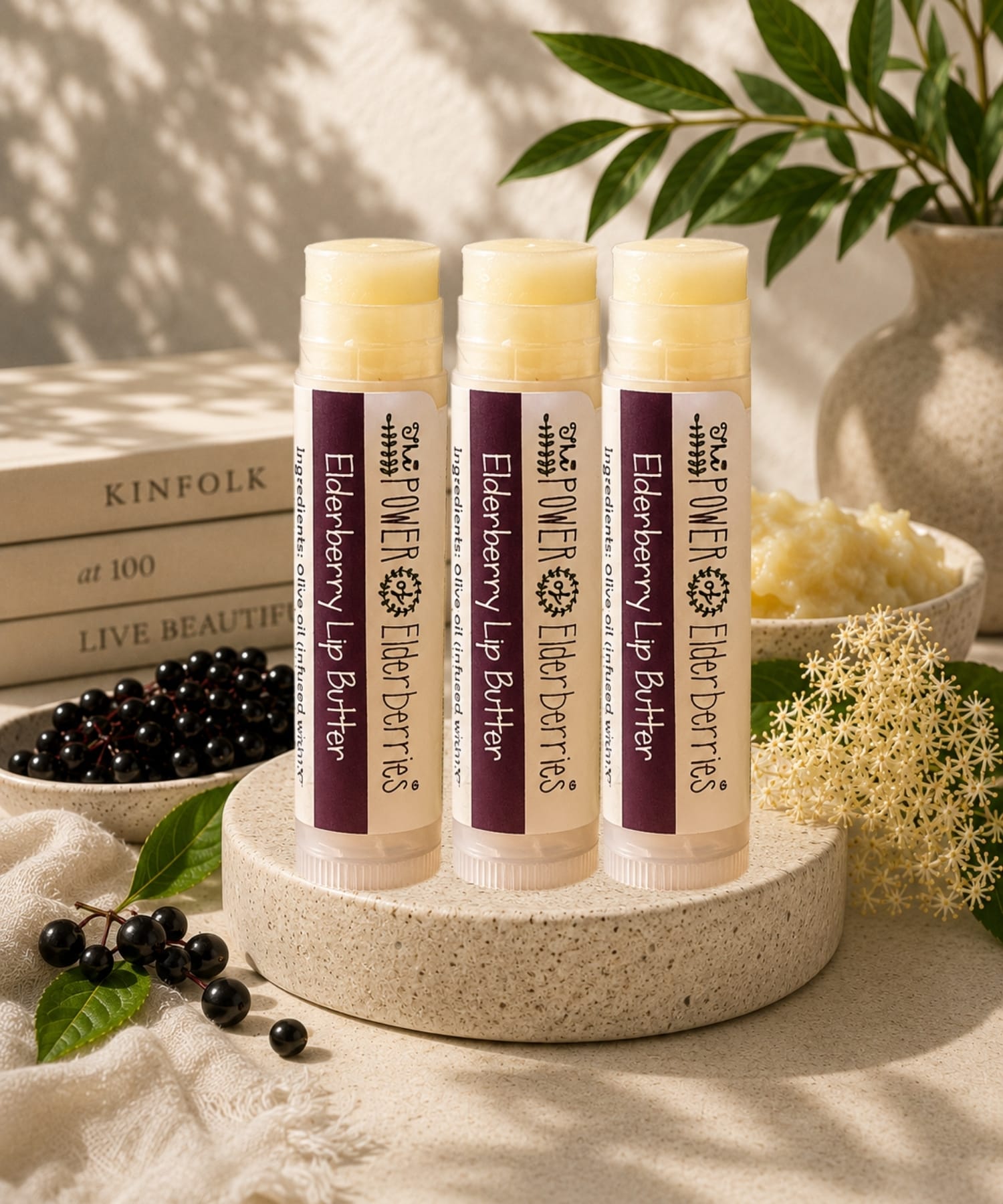 Three elderberry lip butters on a stone surface as the hero image.