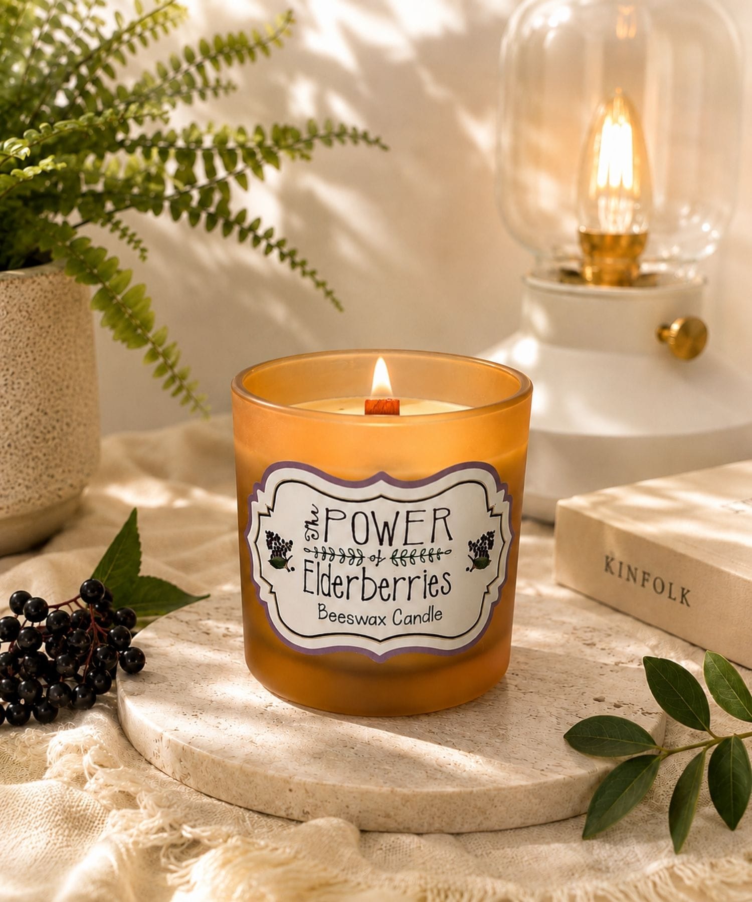 Signature Elderberry Beeswax Candle handcrafted with beeswax and wooden wick in a luxury wellness-inspired setting.