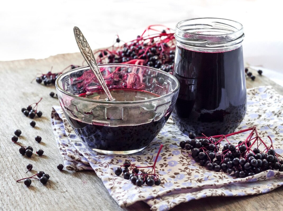 image of elderberries with syrup to show elderberry pills vs syrup comparison