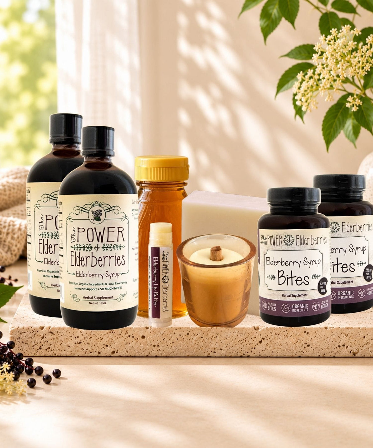 Complete Wellness Ritual Plus+ Bundle with two elderberry syrups, two Bites, honey, lip butter, candle, and soap