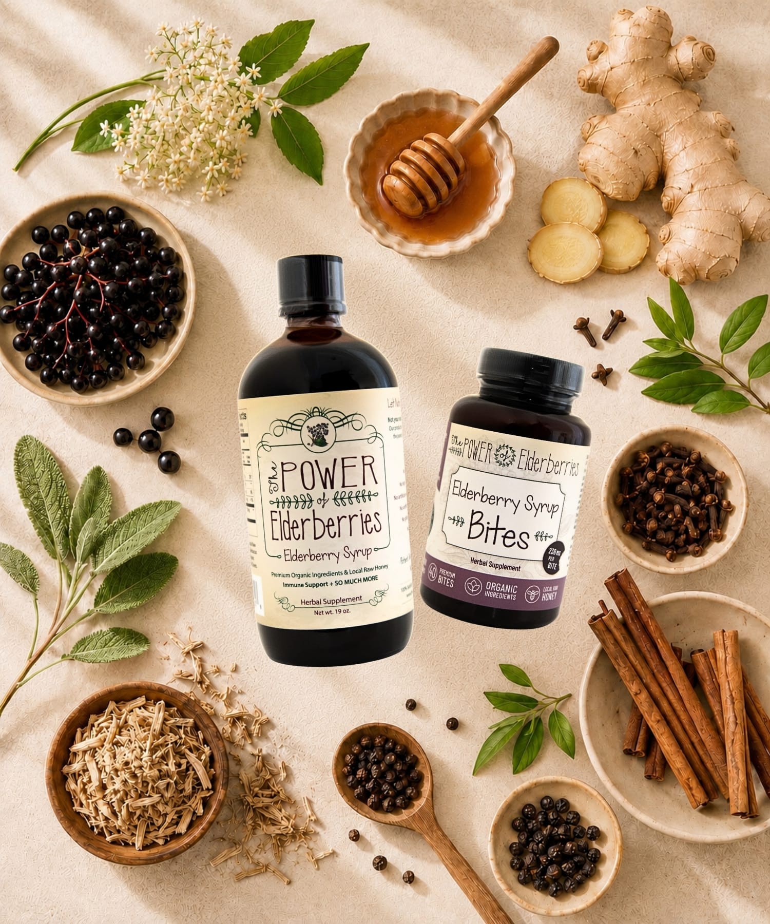 Elderberry syrup and elderberry syrup bites surrounded by organic black elderberries, ginger root, cinnamon sticks, whole cloves, and local raw honey.