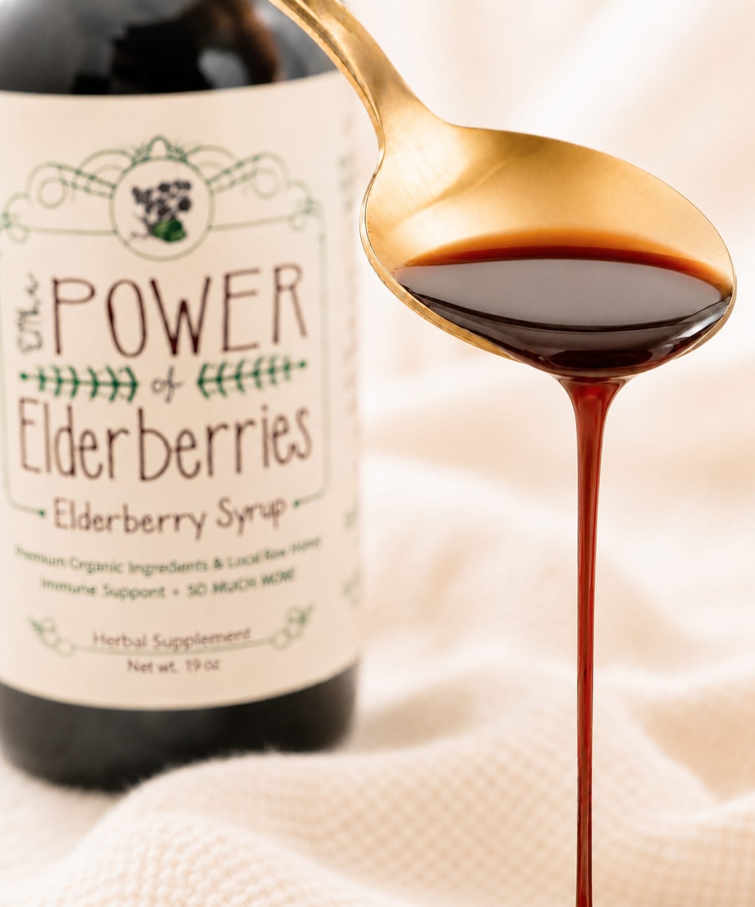 Close-up of handcrafted elderberry syrup 19oz pouring from spoon