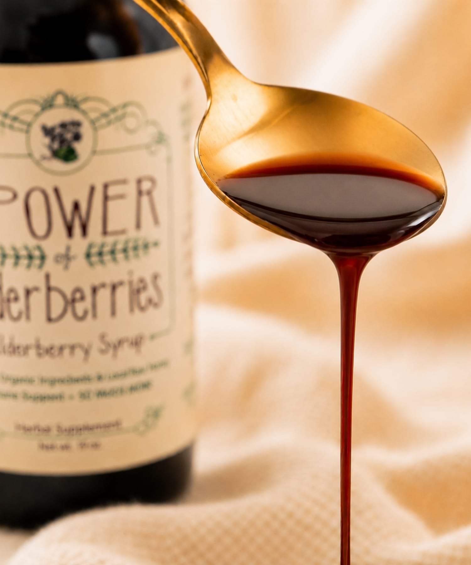 Close-up of handcrafted elderberry syrup pouring from spoon